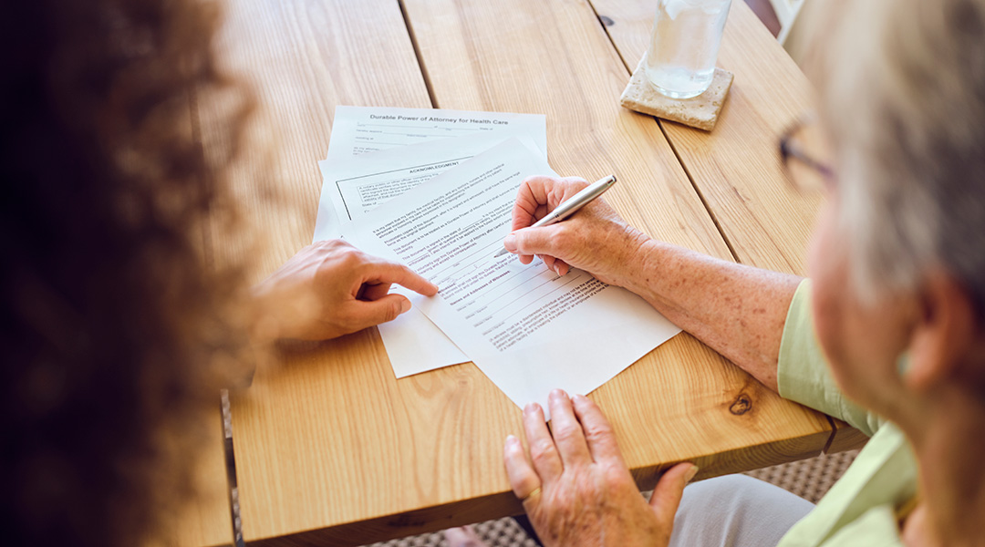 Two people at a table discussing legal documents