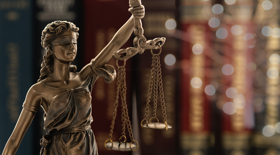 An image of 'Lady Justice,' a blindfolded woman holding a scale