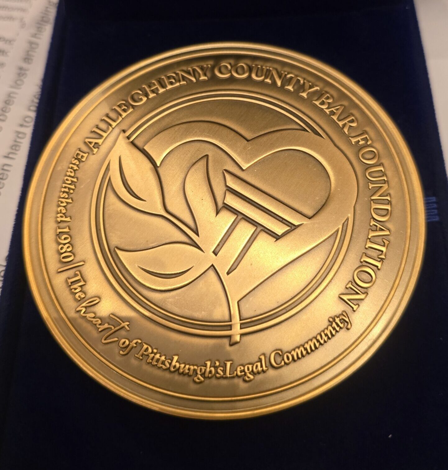 Large bronze medal with inscription.